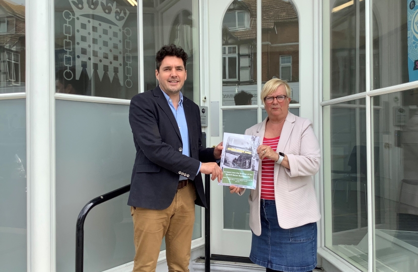 Photo of Huw and Christine Bayliss holding Bexhill bus survey document