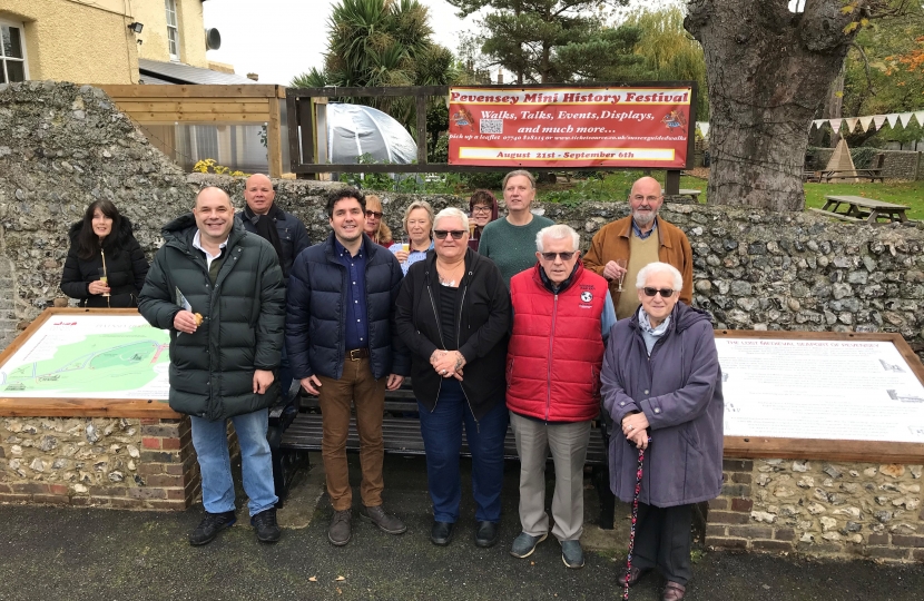 Pevensey community standing with tourism boards