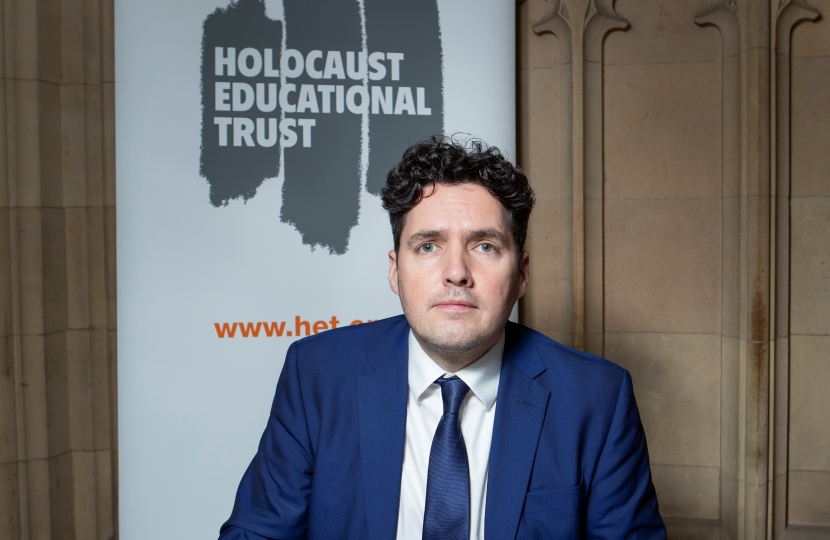 Huw signing Holocaust Memorial Book in Parliament