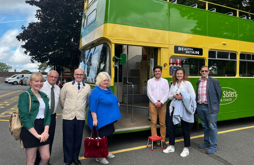 Photo of Huw, Caroline Ansell and Pevensey parish council in front of bus