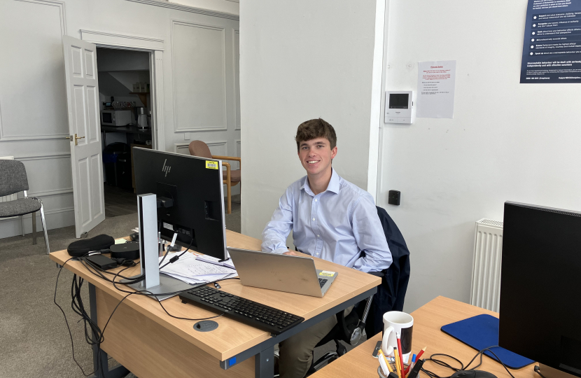 Photo of Freddie at desk in constituency office