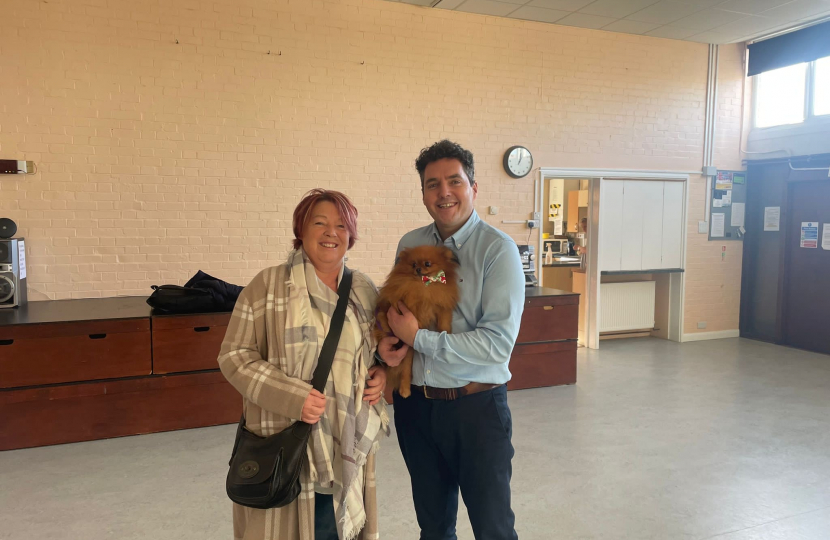 Huw with local dog owner in church hall 