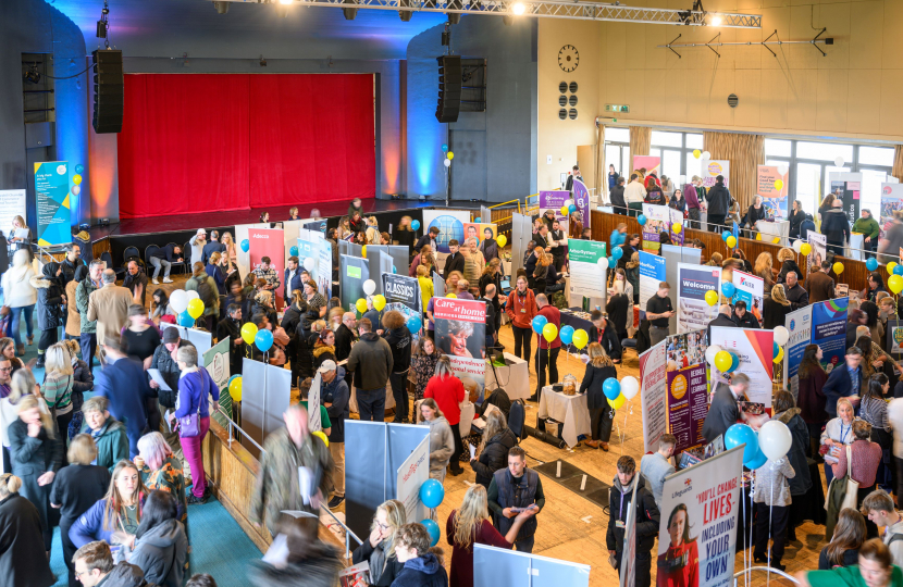 Photo of Jobs Fair in full swing taken from side of auditorium