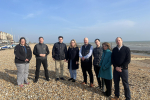 Huw Merriman, Sally-Ann Hart and representatives from Southern Water and EA standing on beach in Bexhill