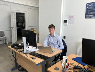 Photo of Freddie at desk in constituency office