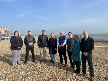 Huw Merriman, Sally-Ann Hart and representatives from Southern Water and EA standing on beach in Bexhill